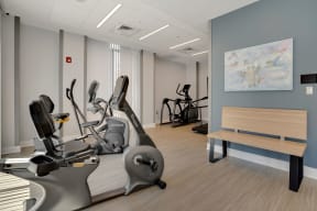 a room filled with exercise equipment and a bench