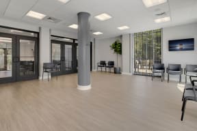 a large room with chairs and a tv on the wall