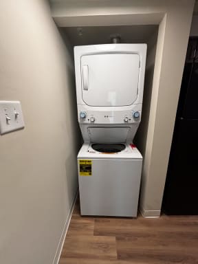 a washer and dryer in a closet in a hotel room