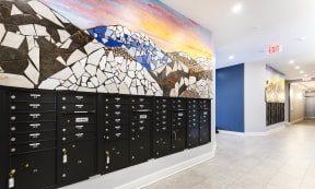 a mural of mountains and rocks is painted on the wall of a school hallway