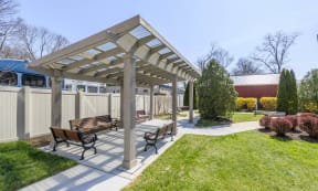 a picnic area with benches and a pergola