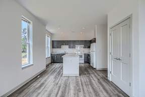 A kitchen with a white island in the middle of the room.