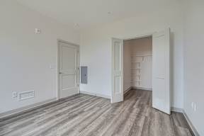 A room with a wooden floor and white walls.