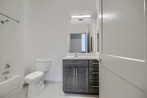 A white toilet sits next to a sink in a bathroom.