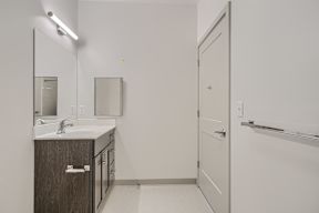 A bathroom with a sink, mirror, and medicine cabinet.