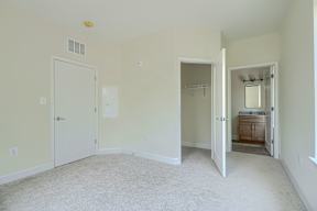A room with a white door and a white wall.