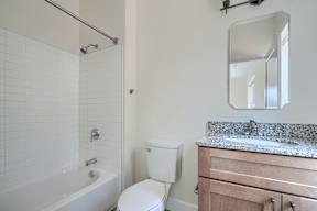 A white toilet sits next to a sink in a bathroom.