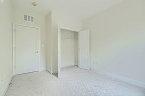 A white room with two doors and one open.