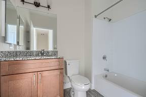 A bathroom with a toilet, sink, and bathtub.