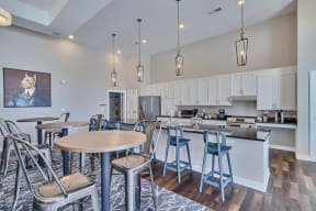 an open kitchen with a dining area and bar with stools