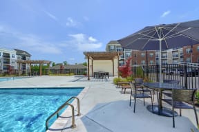 our apartments have a swimming pool with tables and umbrellas