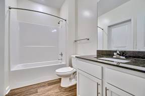 A white bathroom with a walk-in shower and a toilet.