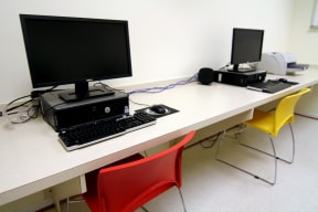 a desk with two computer monitors and two keyboards