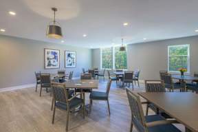 A dining room with a long table and chairs.