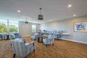 A room with a carpeted floor and a painting on the wall.
