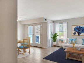 a living room and dining room with a table and chairs