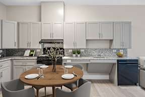 A modern kitchen with a dining table set for two.