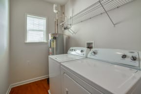 the laundry room has a washer and dryer and a window