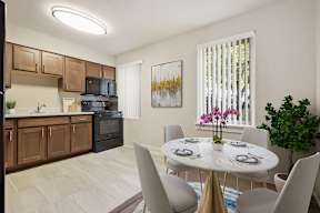 A kitchen with a dining table set for six.