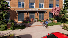 A group of people are standing outside of a building named 4710 Park Heights Plaza.