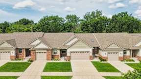 A row of houses with garages in front.