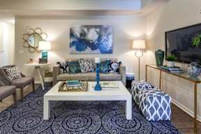 A living room with a white coffee table and a grey sofa.