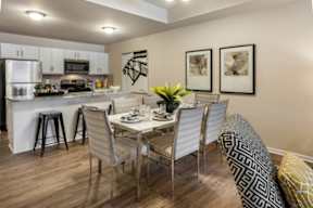 A dining room with a table set for four.