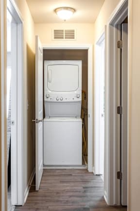 A white oven and fridge in a narrow hallway.