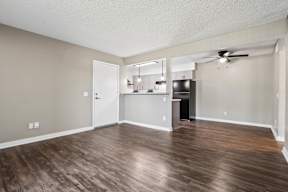 A room with wooden flooring and a ceiling fan.