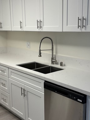 A kitchen with a sink and a dishwasher.