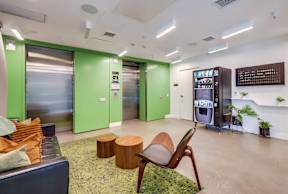 A modern office space with a green and black color scheme.