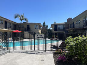 a pool with a keep closed sign in front of apartment buildings