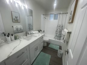 a bathroom with white cabinets and a sink and a toilet