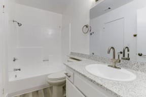 a bathroom with a sink toilet and shower