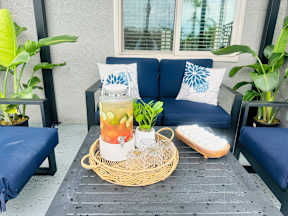 A table with a vase and a basket on it.