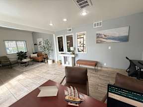 A living room with a brown table and chairs.