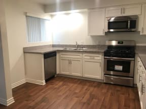 a kitchen with a stove a sink and a microwave