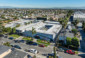 A large building with a parking lot in front of it.