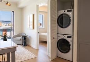 a living room with a washer and a dryer in a door