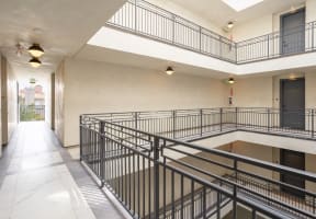 the lobbies of the buildings have balconies with metal railings