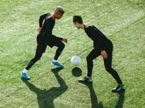 Two young men playing soccer