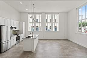 A modern kitchen with stainless steel appliances and a large island.