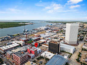 A cityscape with a red pinpoint on a building.