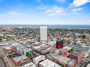 A cityscape with a red pin marking a specific location.