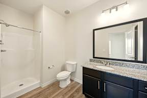 A bathroom with a toilet, sink, and shower.