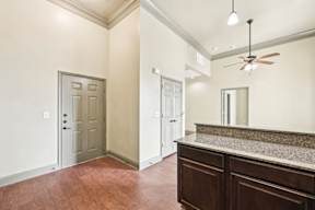 A room with a wooden floor and a marble countertop.