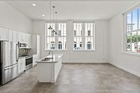 A modern kitchen with white cabinets and stainless steel appliances.