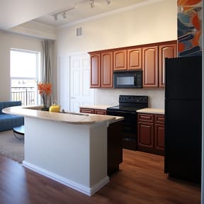 a kitchen with a large island and black appliances