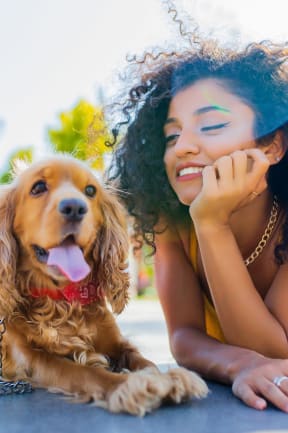 a woman laying on the ground with her dog