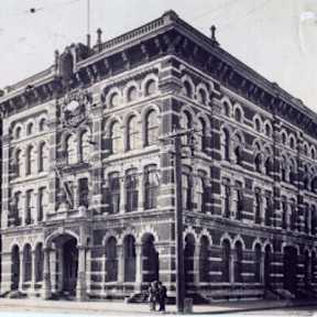 An old building with a clock on the front.